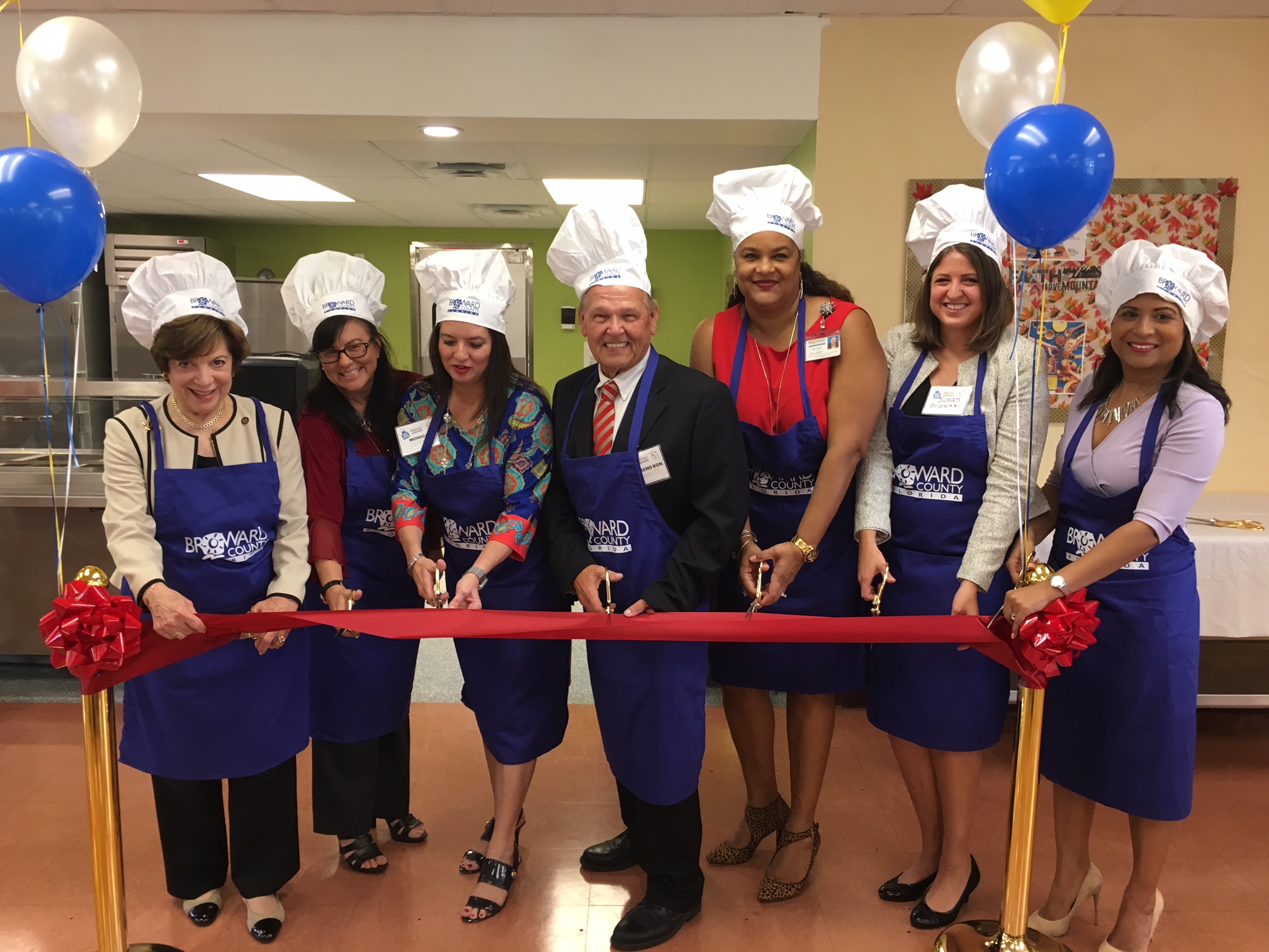 Dignitaries participate in the North Homeless Assistance Center Kitchen ribbon cutting ceremony.