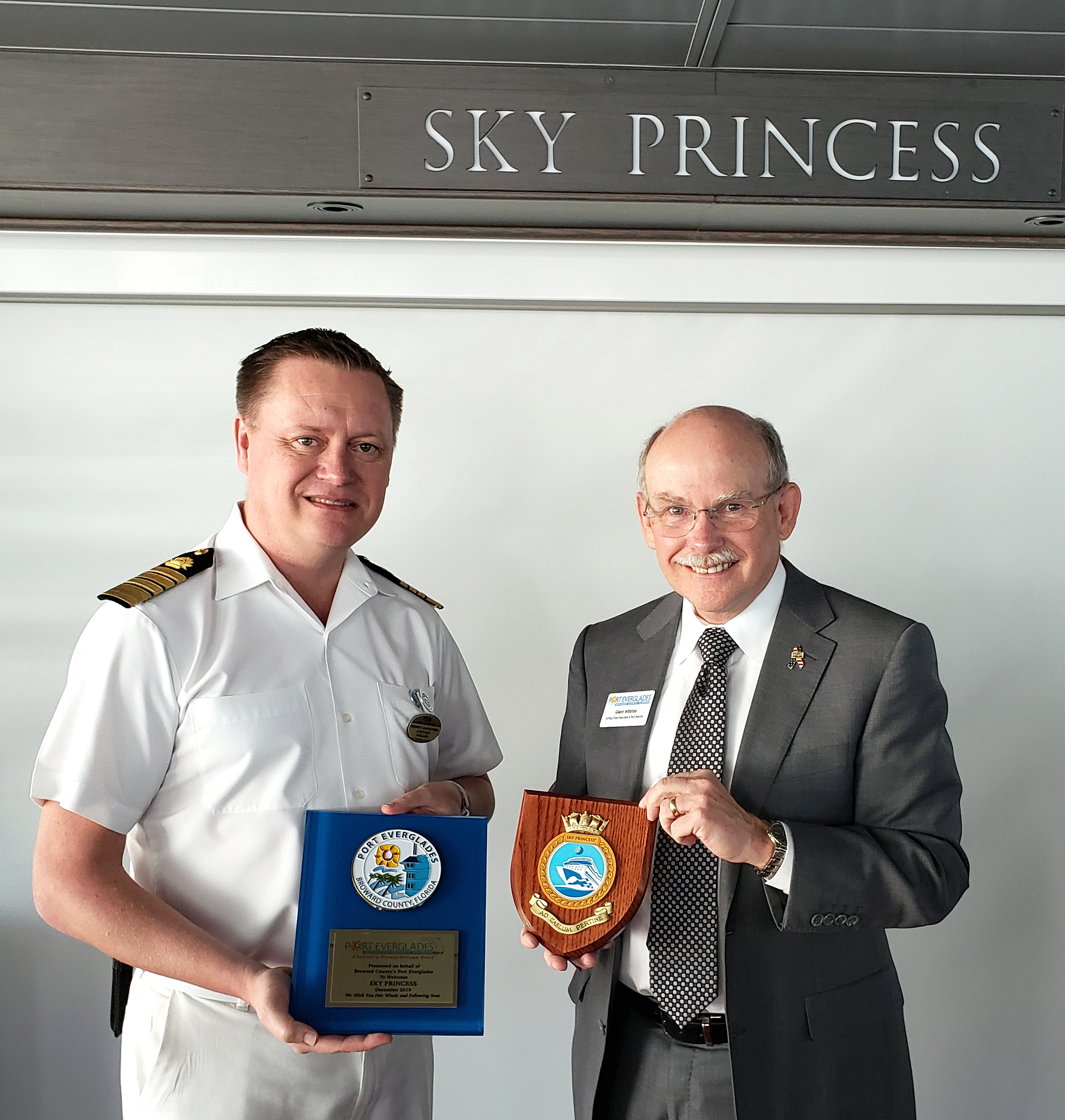 Acting Chief Executive & Port Director Glenn Wiltshire (right) and Sky Princess Captain Heikki Laakkonen exchange plaques aboard the Sky Princess. 