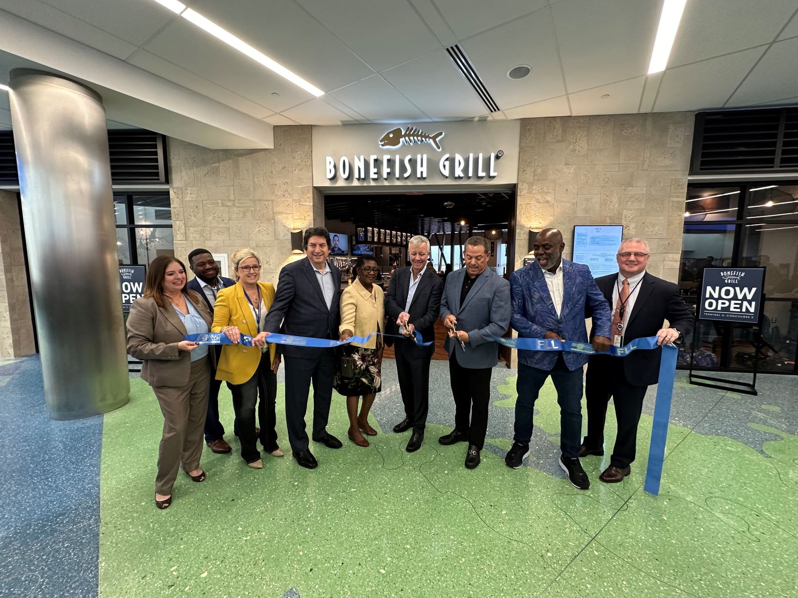 FLL, Delaware North, and Broward County Government officials participate in the ribbon-cutting ceremony for the airport's new Bonefish Grill restaurant.