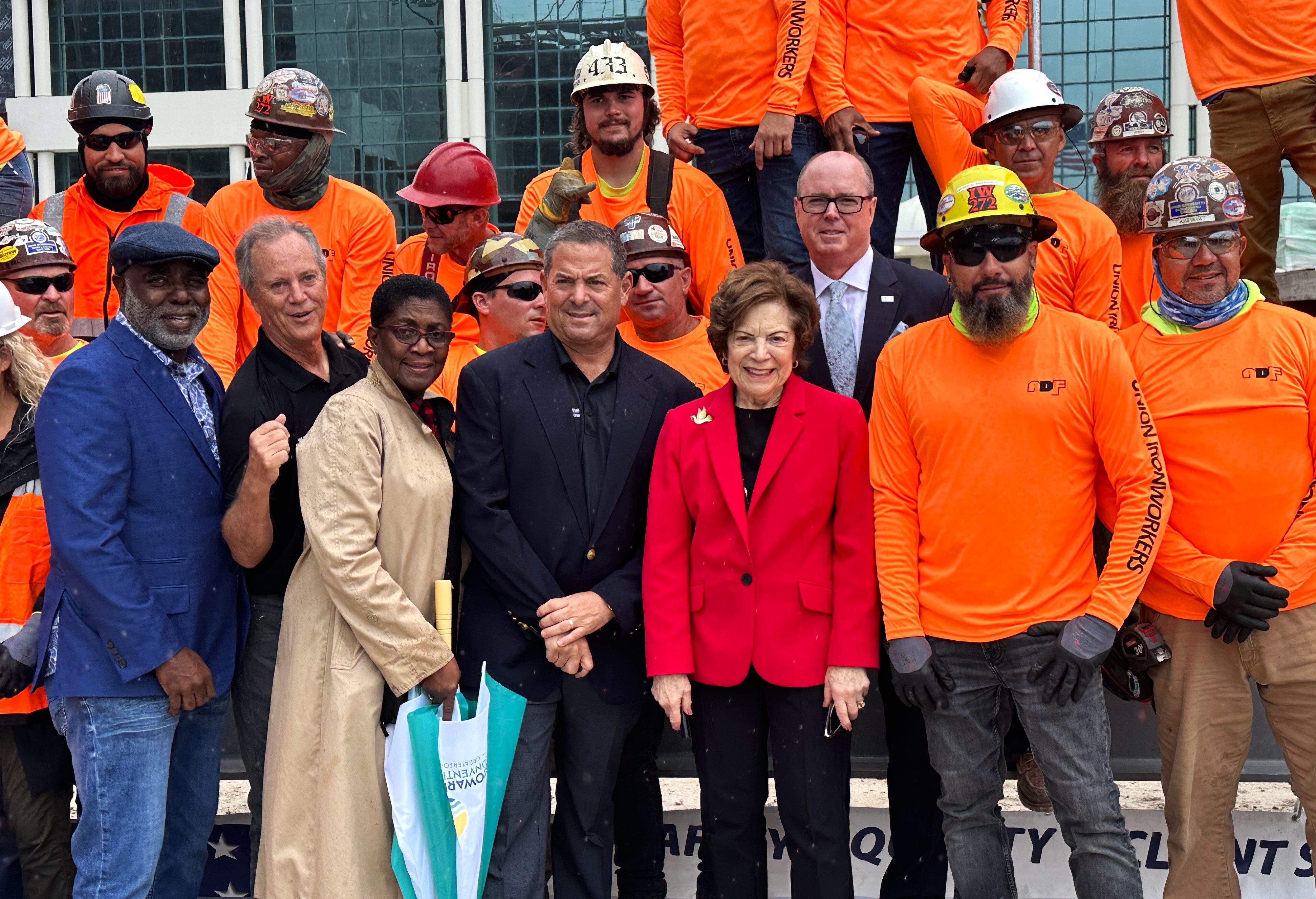 Broward Commissioners join construction workers in celebration of topping out of the new 29-story Convention Center Hotel and Convention Center Expansion.  Topping out marks the completion of the framework of a building. 